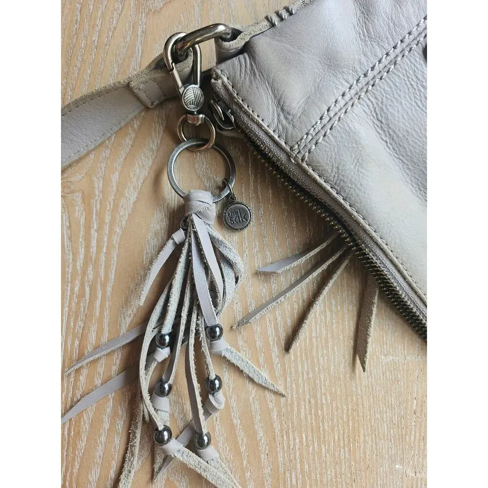 The Sak Stone Gray Leather Crossbody, adjustable, tassel detail